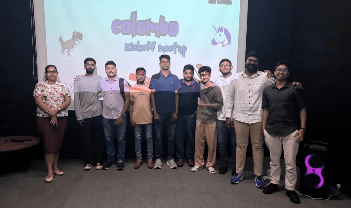Members stand together on stage at the kickoff party of a new chapter.